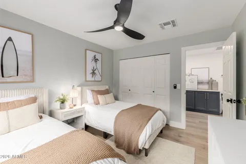 a bedroom with two beds and painted walls