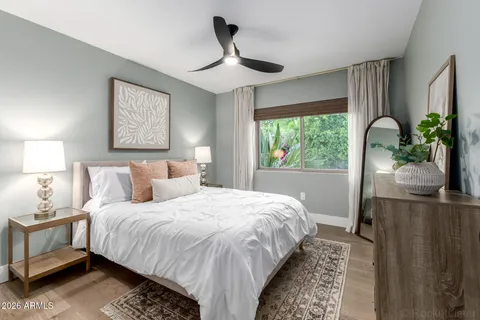 a bedroom with bed and a large window