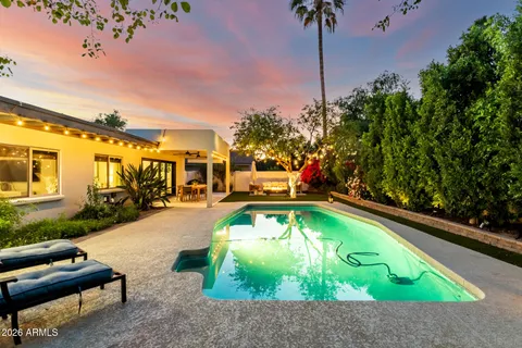 an aerial view of residential houses with outdoor space and trees