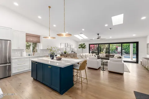 a kitchen with counter top space and living room
