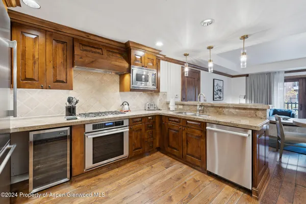 a kitchen with stainless steel appliances granite countertop a stove and a sink