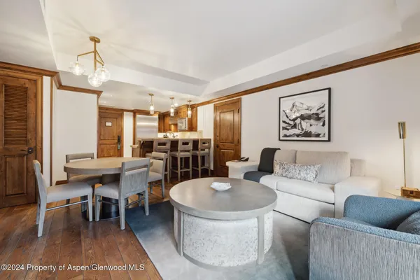 a living room with furniture a dining table and a piano
