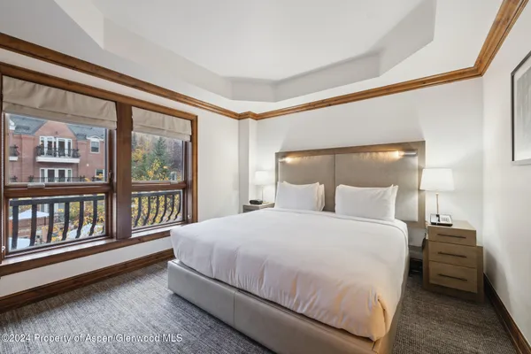 a bedroom with a large bed and a large window