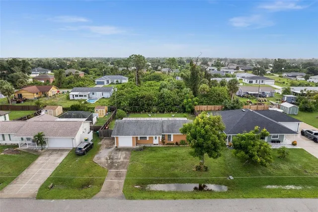 an aerial view of a house with a yard