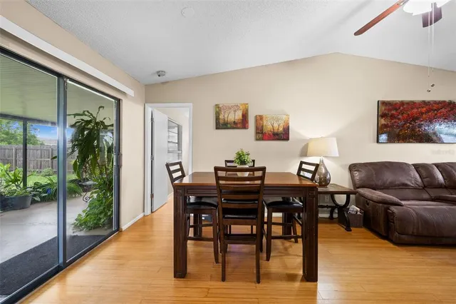 a view of a dining room with furniture and wooden floor