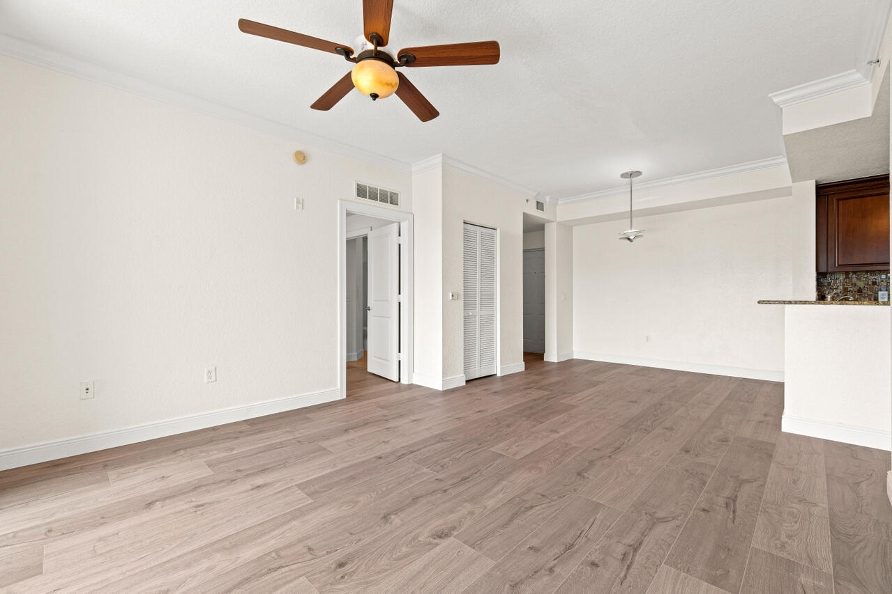 1660 Renaissance Commons Boulevard, Unit 2524 Boynton Beach, FL 33426 - Photo 6 of 27 a view of empty room with wooden floor and ceiling fan