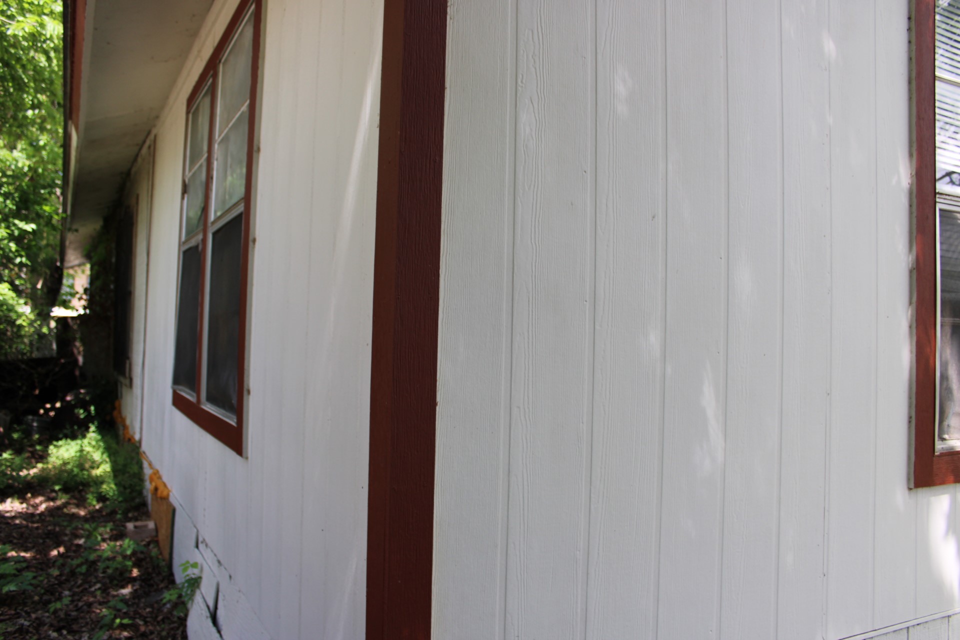 3017 Lyons Road Austin, TX 78702 - Photo 9 of 16 The property features white panel siding and windows with dark trim