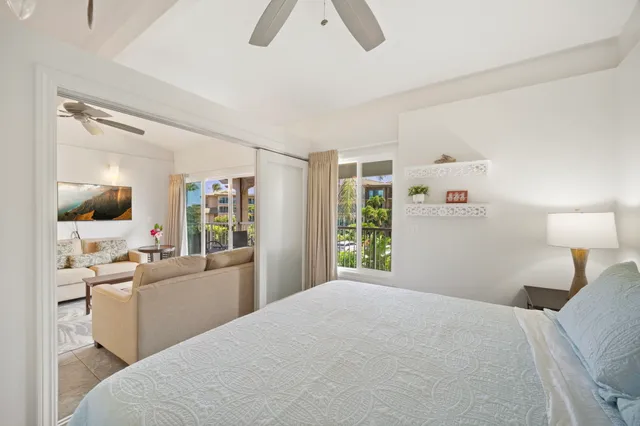 a room with a bed a couch and a window