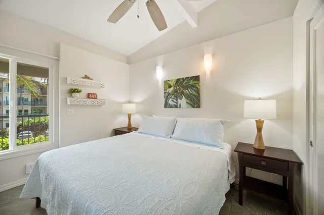 a bedroom with a bed and a large window