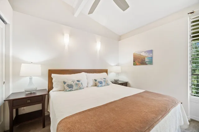 a bedroom with a bed and a lamp