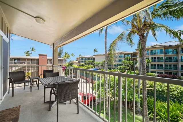 a view of a chairs and table in patio with a barbeque
