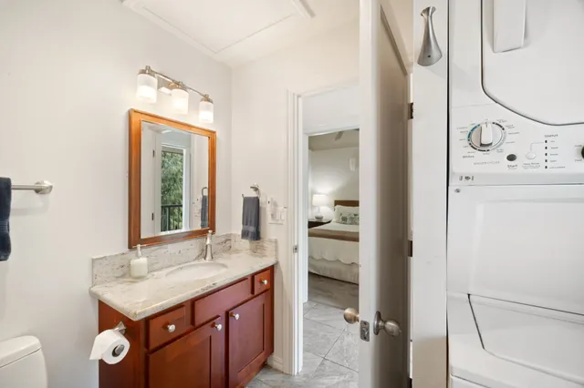 a bathroom with a sink a toilet and a mirror