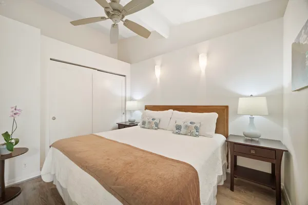 a bedroom with a bed and a chandelier