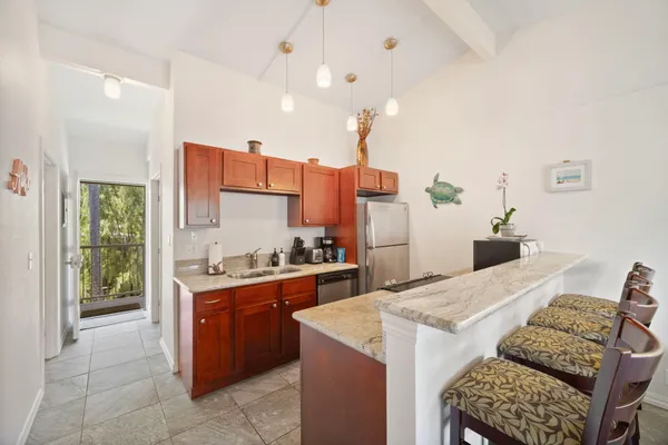 a kitchen with a stove a refrigerator and a sink