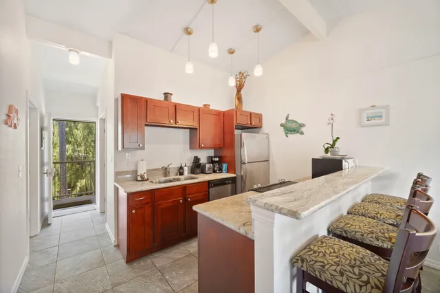 a kitchen with a stove a refrigerator and a sink