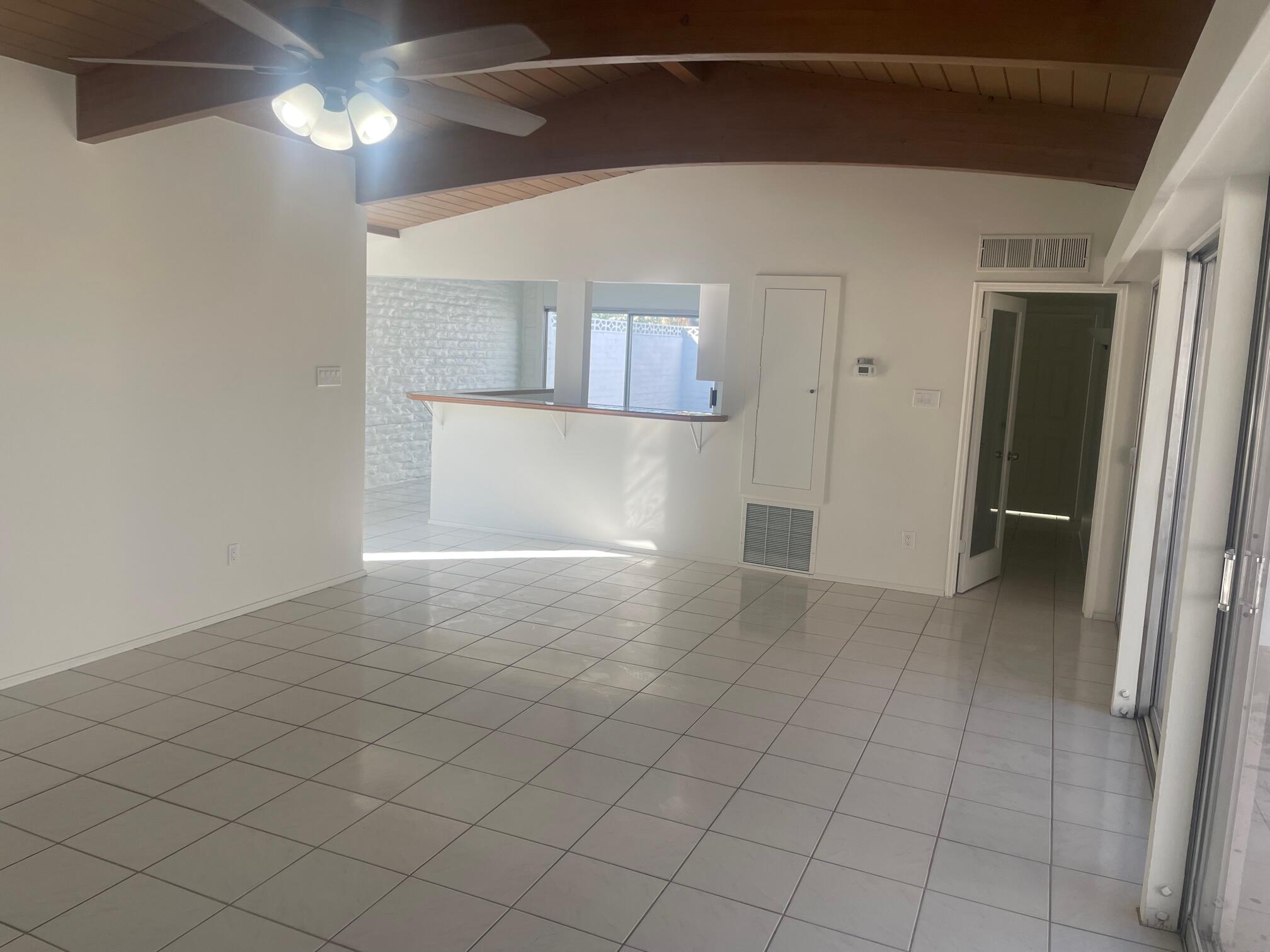 2630 North Biskra Road Palm Springs, CA 92262 - Photo 4 of 10 a view of an empty room with wooden floor