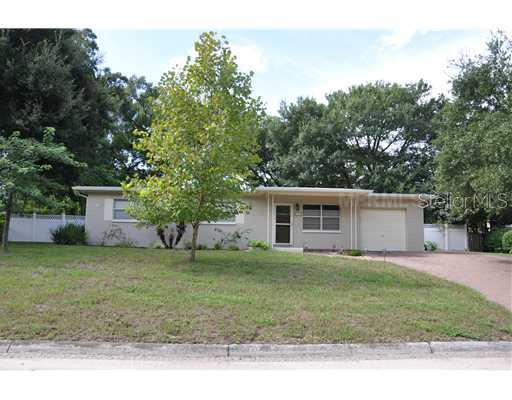 Exterior Front - A wide expanse of grass that In just a few more years will be gently shaded by the sycamore and floss silk trees.  Note the generous side setbacks and the beautiful paver brick drive with addtional parking off to the side of the garage.