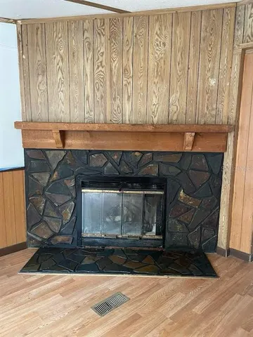 a room with a fireplace and a wooden floor