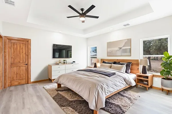 a bedroom with a bed and a flat screen tv