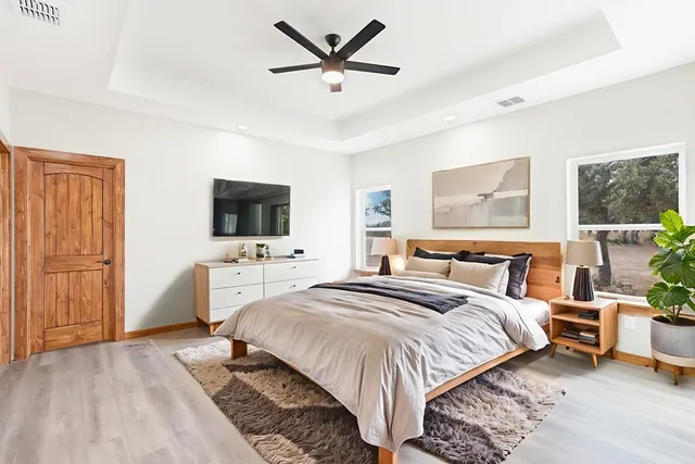 a bedroom with a bed and a flat screen tv