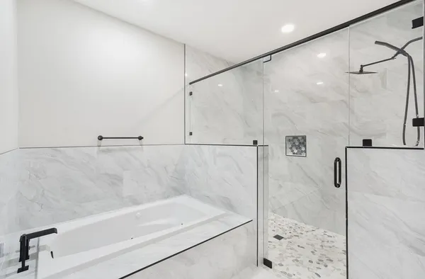 a bathroom with a shower and a bath tub