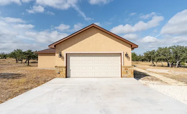 a view of a house with a backyard