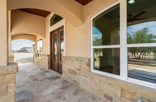 a white house that has a tree in front of it