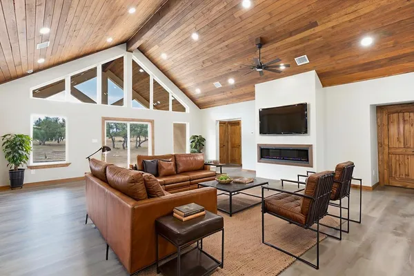 a living room with fireplace furniture and a flat screen tv
