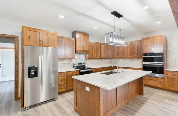 a kitchen that has a lot of cabinets in it