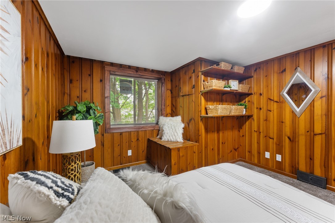 3568 McCartney Road Youngstown, OH 44505 - Photo 23 of 29 Bedroom with wooden walls and light carpet