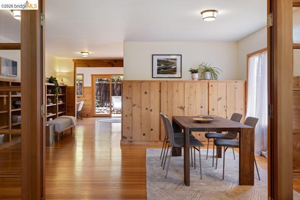 287 Purdue Avenue Kensington, CA 94708 - Photo 16 of 60 Dining area featuring wood paneling and a large window with sheer drapes