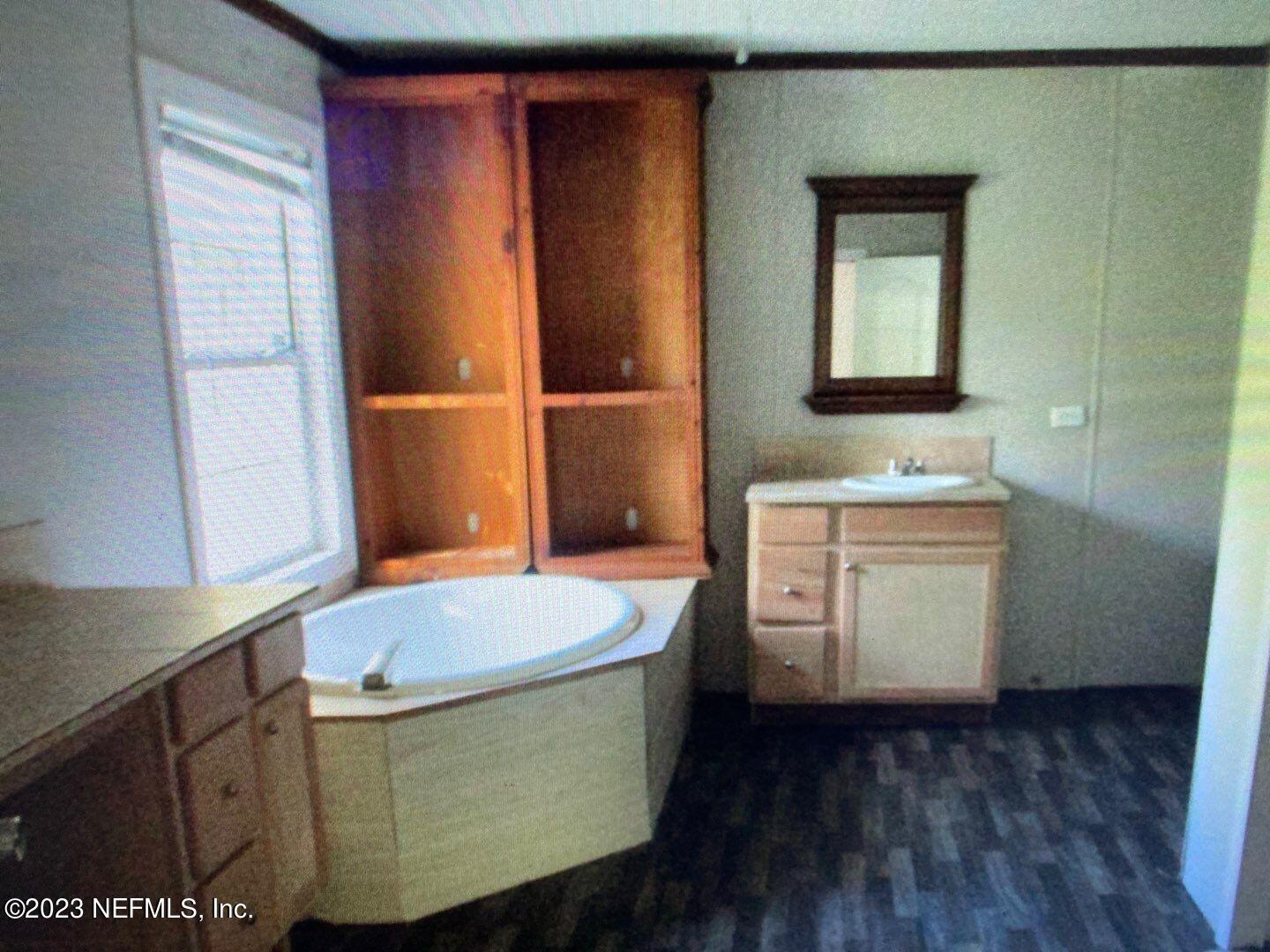 518 Forgotten Way Jacksonville, FL 32221 - Photo 12 of 19 a bathroom with a sink a toilet and mirror