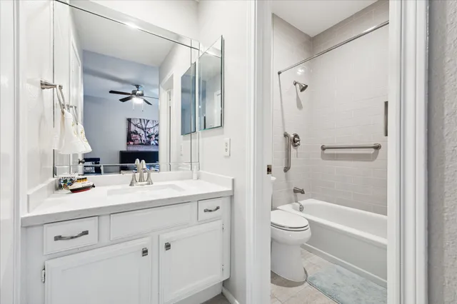 a bathroom with a sink a toilet and a large mirror