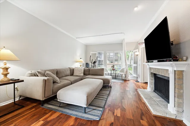 a living room with fireplace furniture and a flat screen tv