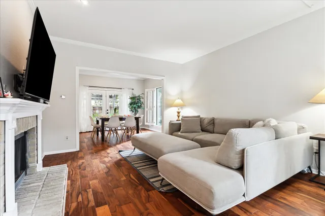 a living room with furniture a flat screen tv and a fireplace