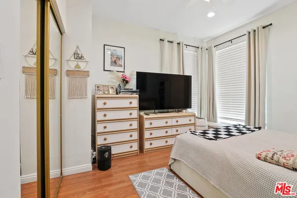 a bedroom with a bed and a flat screen tv