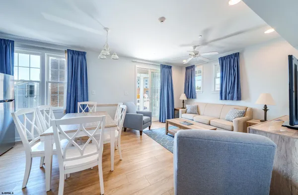 a living room with furniture a dining table and chairs
