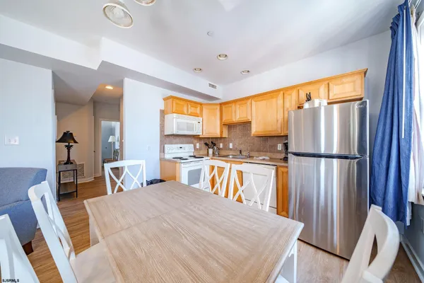 a kitchen with kitchen island a large counter top space appliances and a window