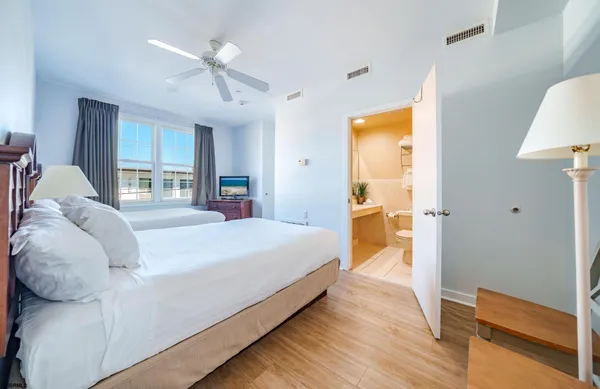 a bedroom with a bed and a lamp