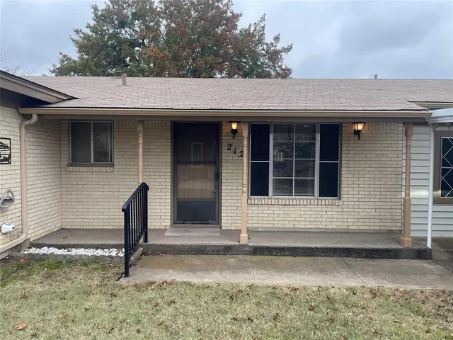 a view of front door and a yard