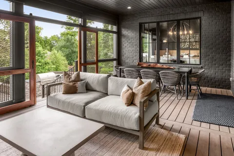 a living room with furniture and large windows
