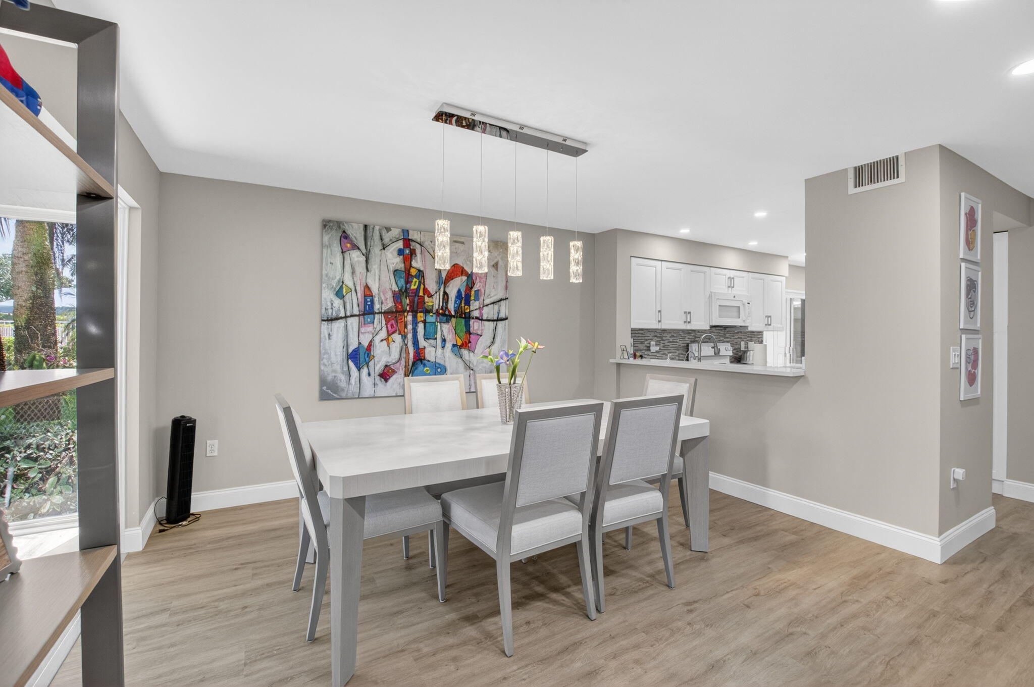 7669 Springwater Place, Unit 102 Boynton Beach, FL 33437 - Photo 12 of 116 a view of a dining room with furniture and wooden floor