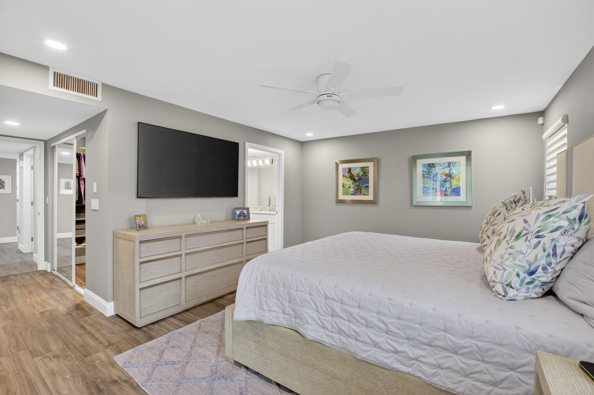 7669 Springwater Place, Unit 102 Boynton Beach, FL 33437 - Photo 23 of 116 a bedroom with a large bed and a flat screen tv