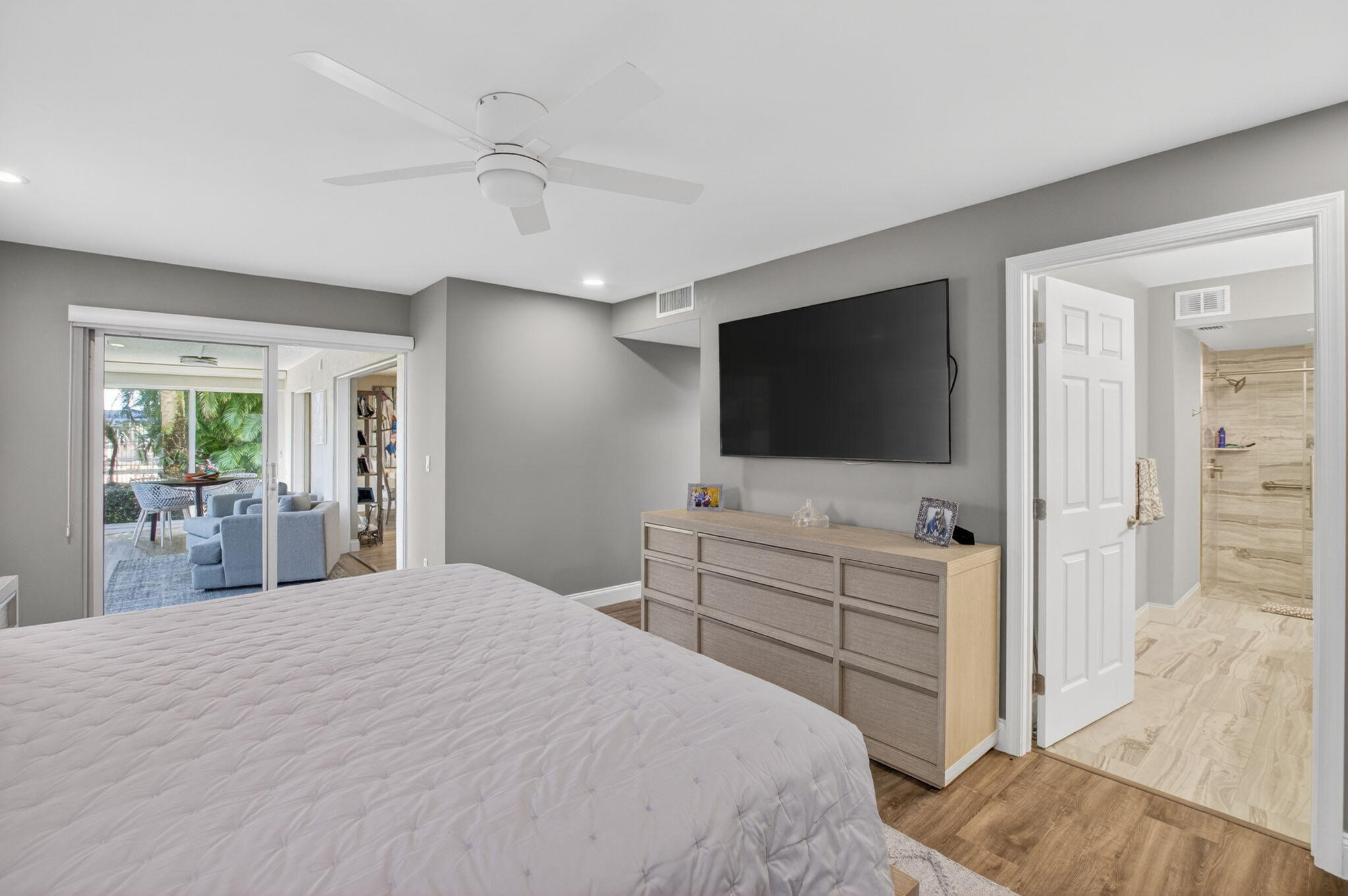 7669 Springwater Place, Unit 102 Boynton Beach, FL 33437 - Photo 25 of 116 a bedroom with a bed and a flat screen tv in it