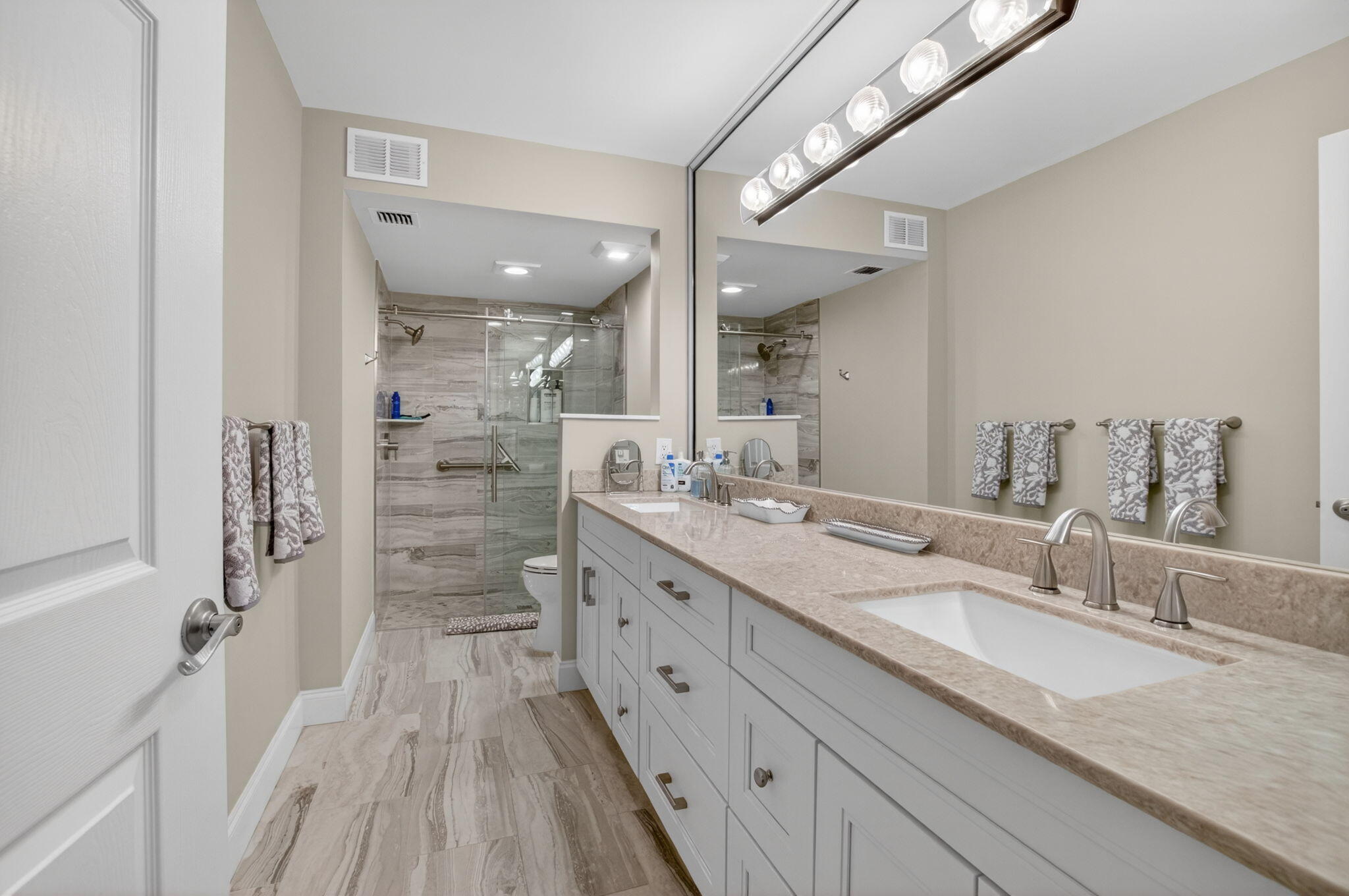 7669 Springwater Place, Unit 102 Boynton Beach, FL 33437 - Photo 26 of 116 a spacious bathroom with a granite countertop sink mirror and shower