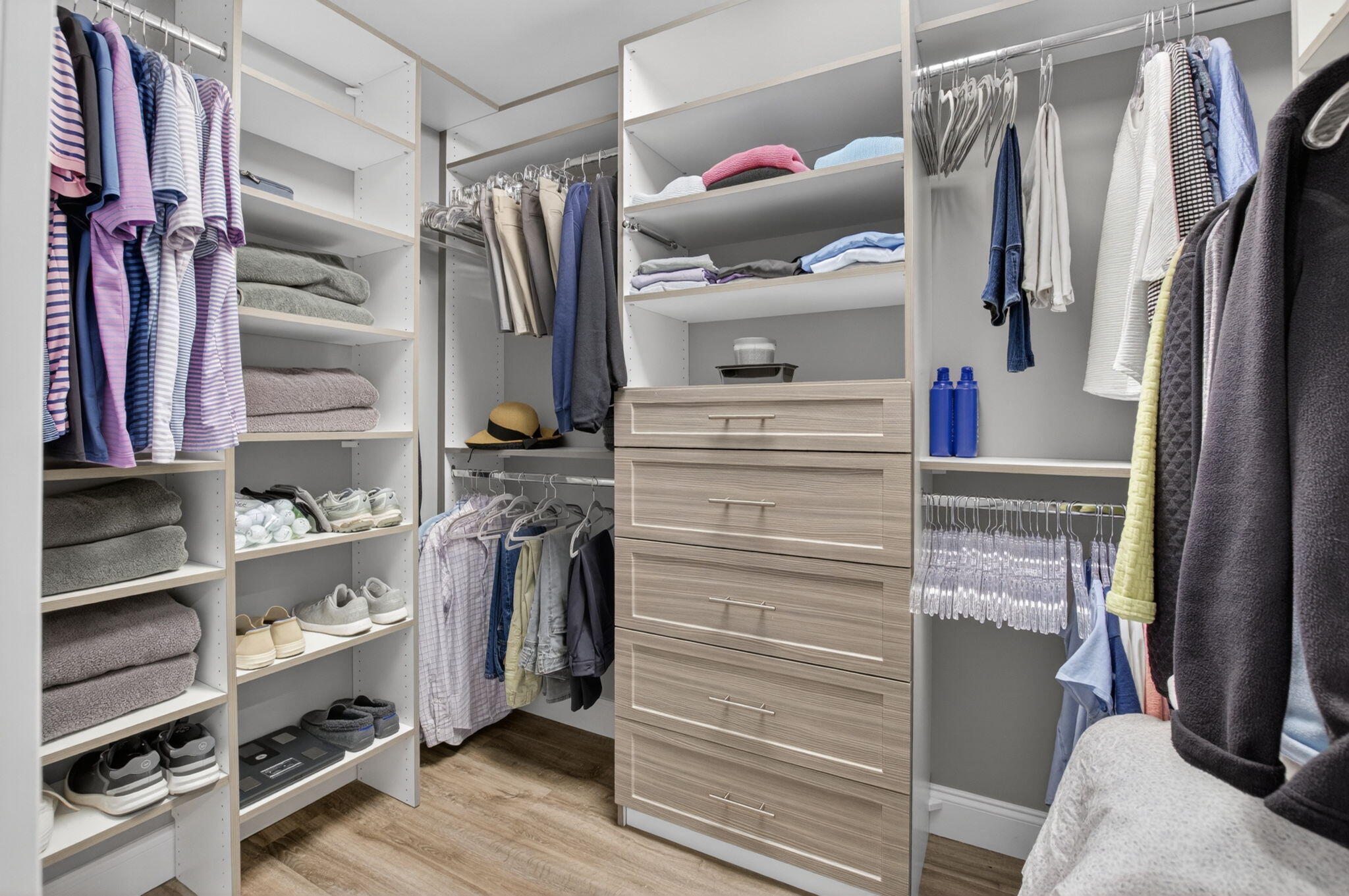 7669 Springwater Place, Unit 102 Boynton Beach, FL 33437 - Photo 29 of 116 a view of walk in closet with clothes and shoes