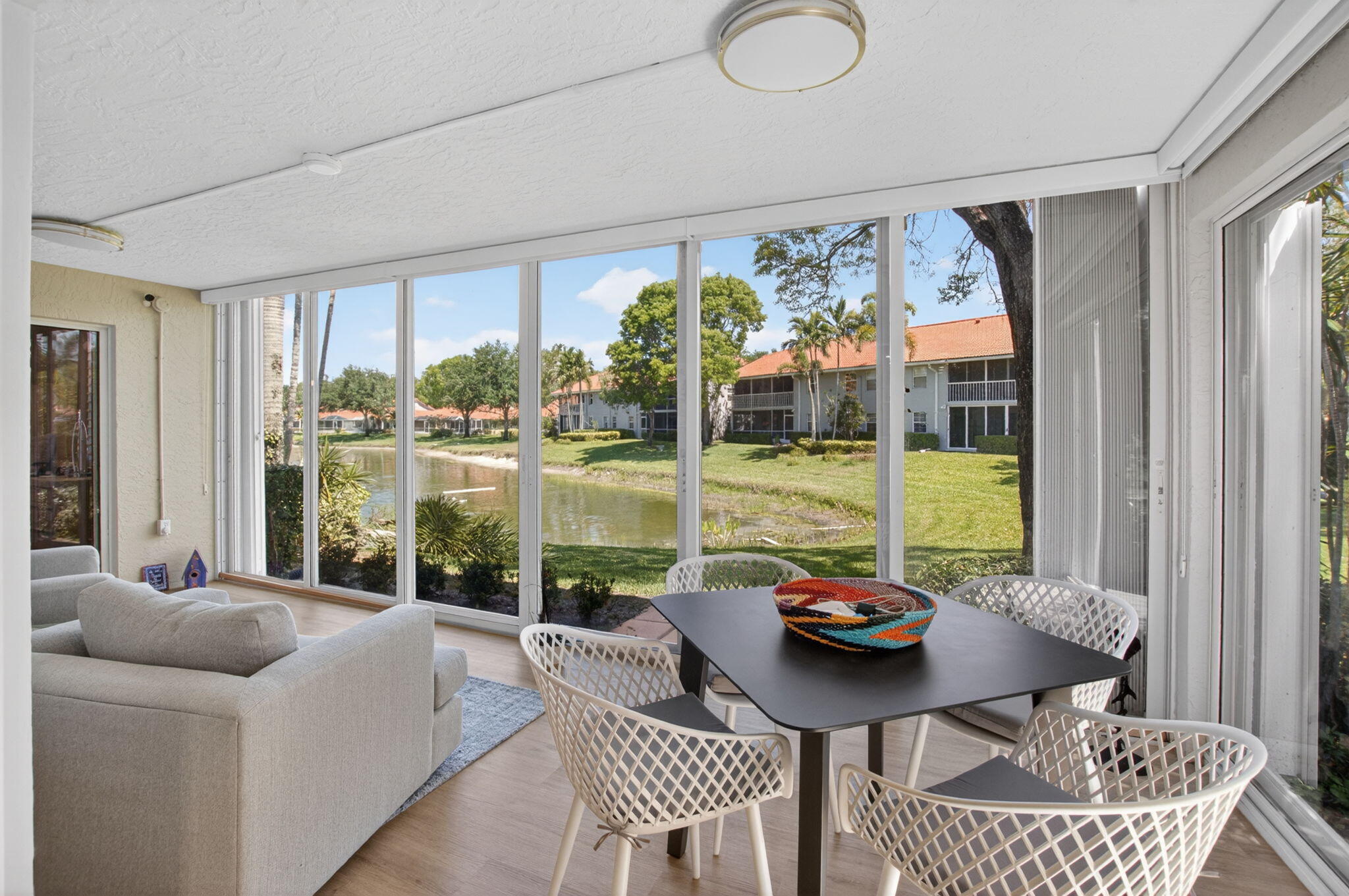 7669 Springwater Place, Unit 102 Boynton Beach, FL 33437 - Photo 39 of 116 a living room with furniture and a large window