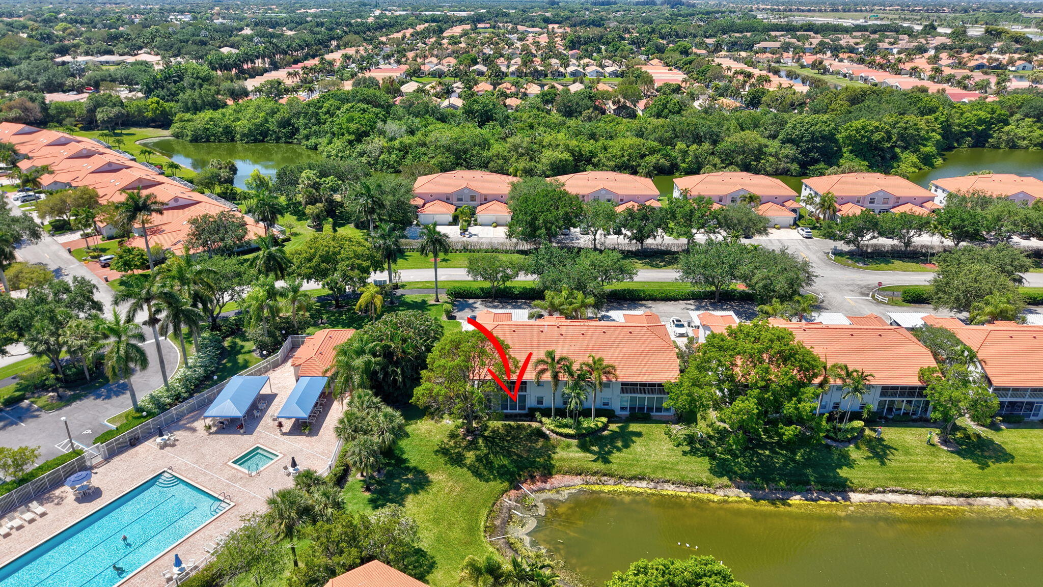 7669 Springwater Place, Unit 102 Boynton Beach, FL 33437 - Photo 48 of 116 an aerial view of residential houses with outdoor space and lake view