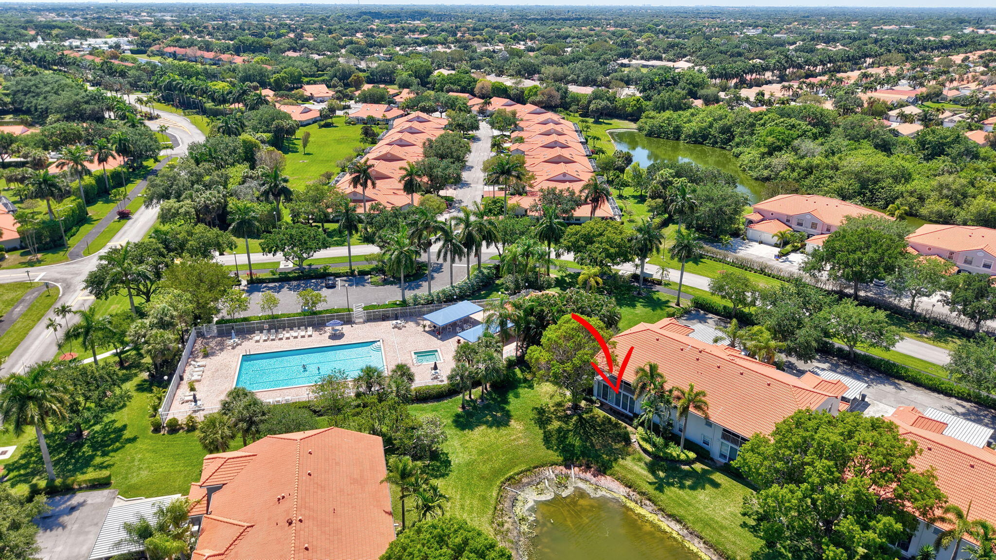 7669 Springwater Place, Unit 102 Boynton Beach, FL 33437 - Photo 49 of 116 an aerial view of residential houses with outdoor space and trees