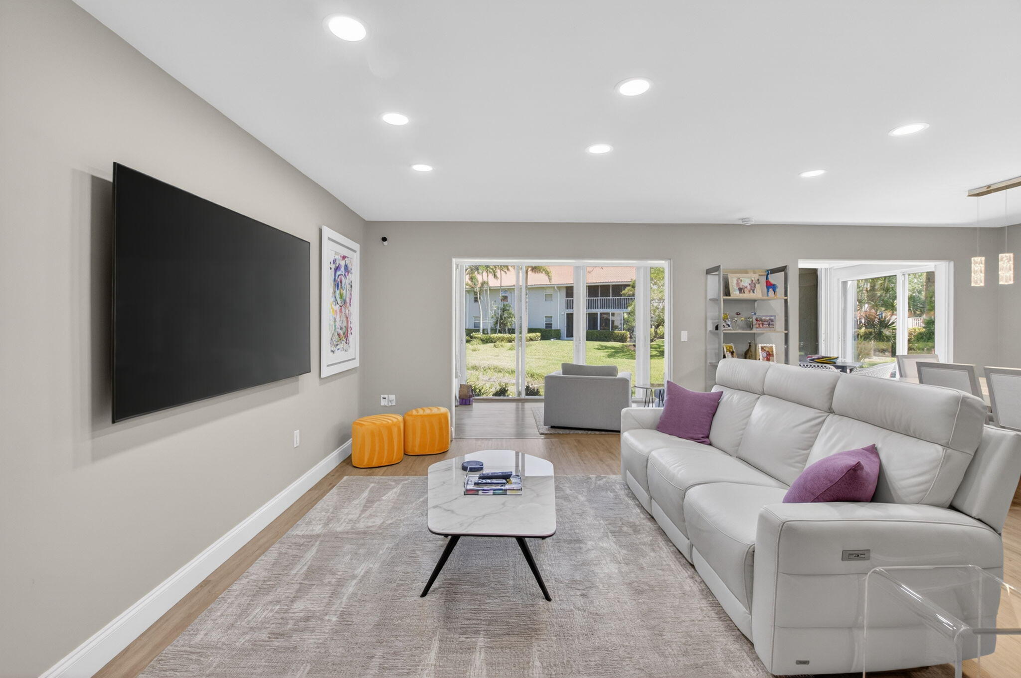7669 Springwater Place, Unit 102 Boynton Beach, FL 33437 - Photo 6 of 116 a living room with furniture and a flat screen tv
